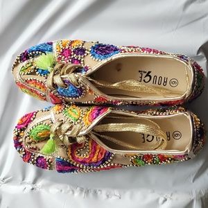 Multi color size 6 Rouge shoes with gold shoe srings and green tassels.